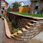 Rounded retaining wall with steps, plants and divider